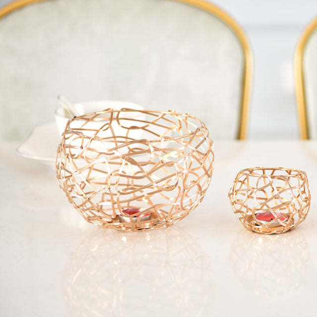 3 piece gold hollow out iron candle holder set on the table