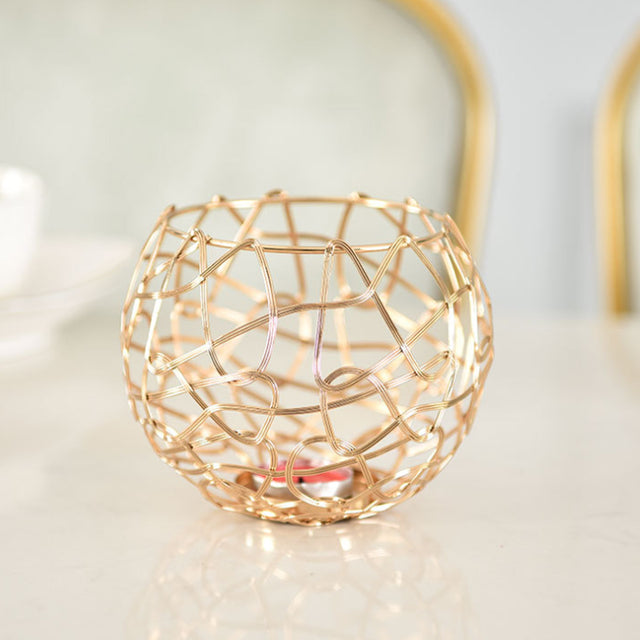 3 piece gold hollow out iron candle holder set on the table