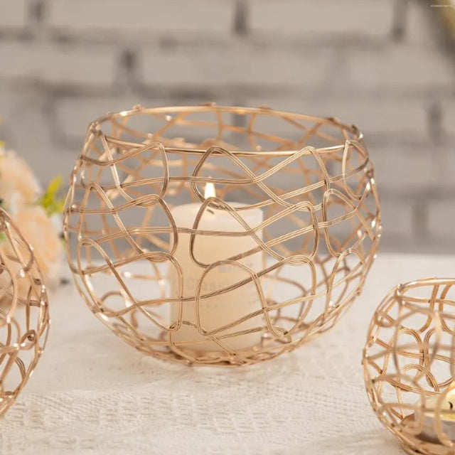 3 piece gold hollow out iron candle holder set on the table