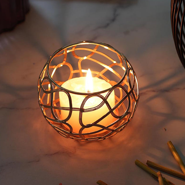 3 piece gold hollow out iron candle holder set on the table