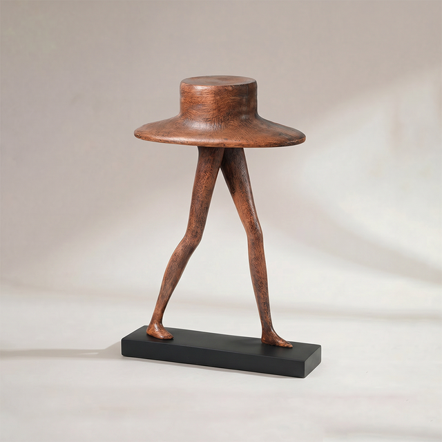 Abstract wide hat walking leg figurine