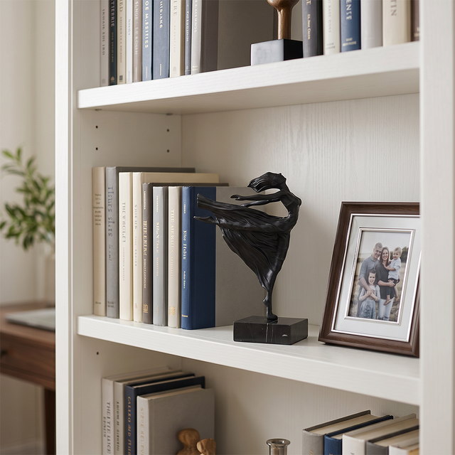 Ballerina figurine on white bookshelf