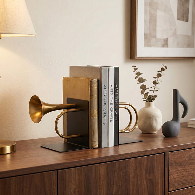 Brass trumpet bookends on wood entry sideboard