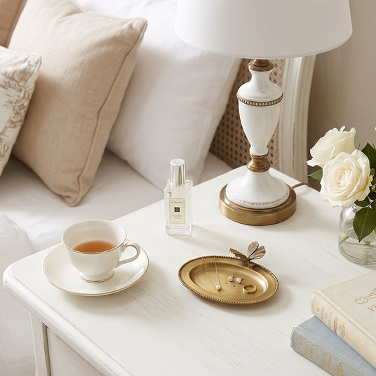 Butterfly ring plate on cream bedside table