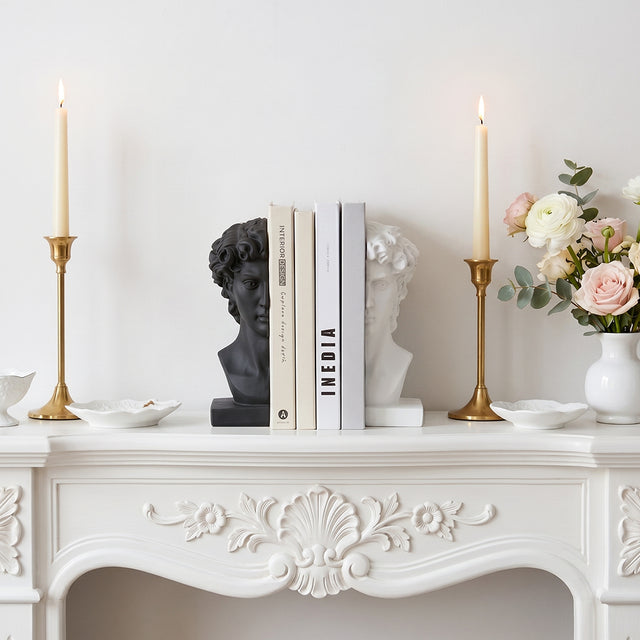 Classical bookends placed on vintage fireplace