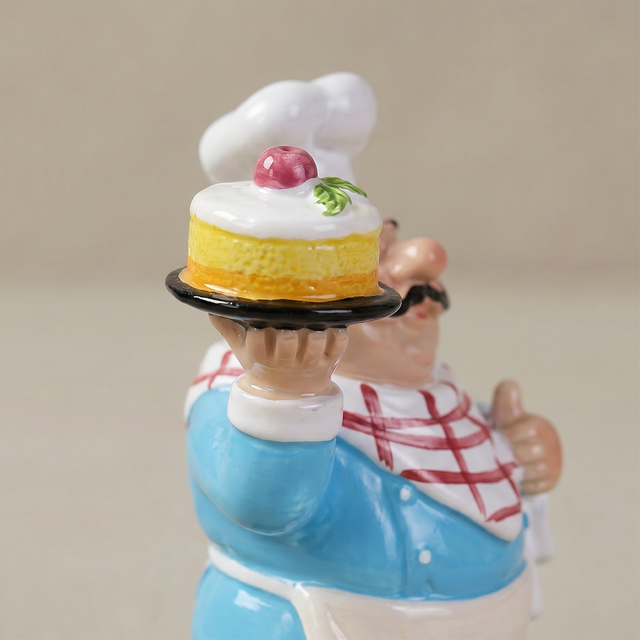 Closeup chef holding cake sculpture