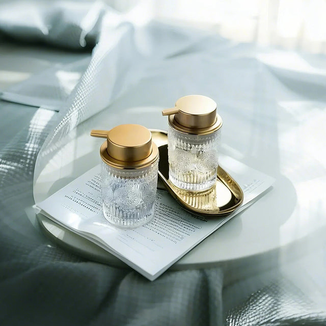 Glass Bathroom Dispenser Set on the table
