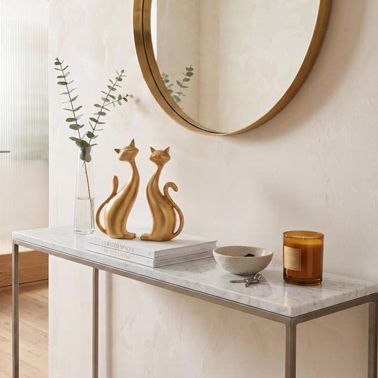 Gold Cat Sculptures On Marble Console