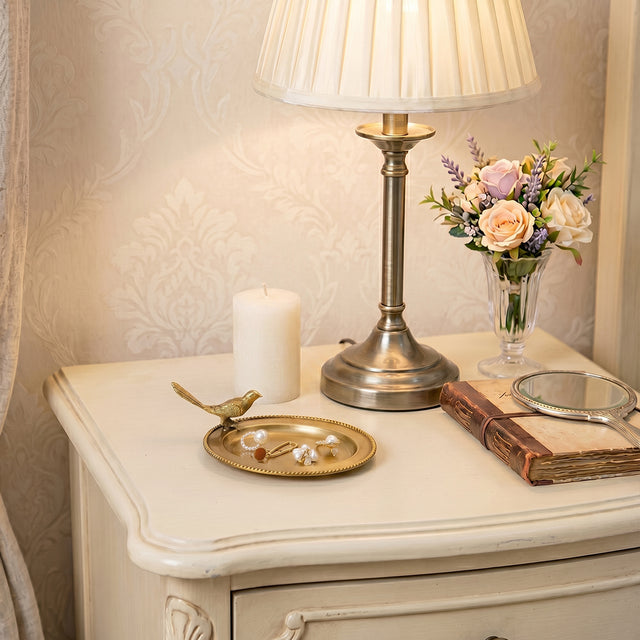 Gold bird tray on cream bedside console