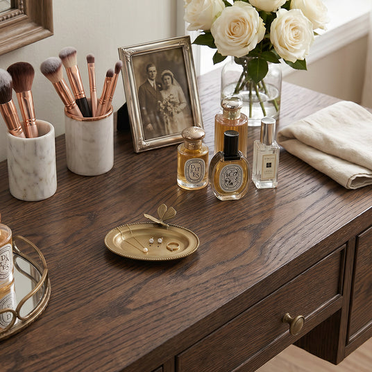 Golden butterfly dish on dark vanity tabletop