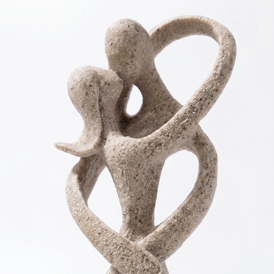 Intertwined Figure Heads Close Up