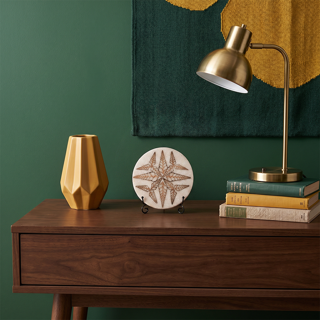Leaf pattern stone plate on dark wood entry console
