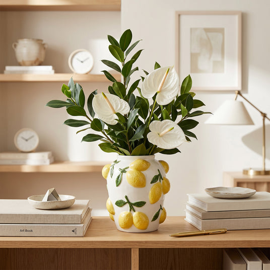 Lemon Vase With White Anthuriums On Desk