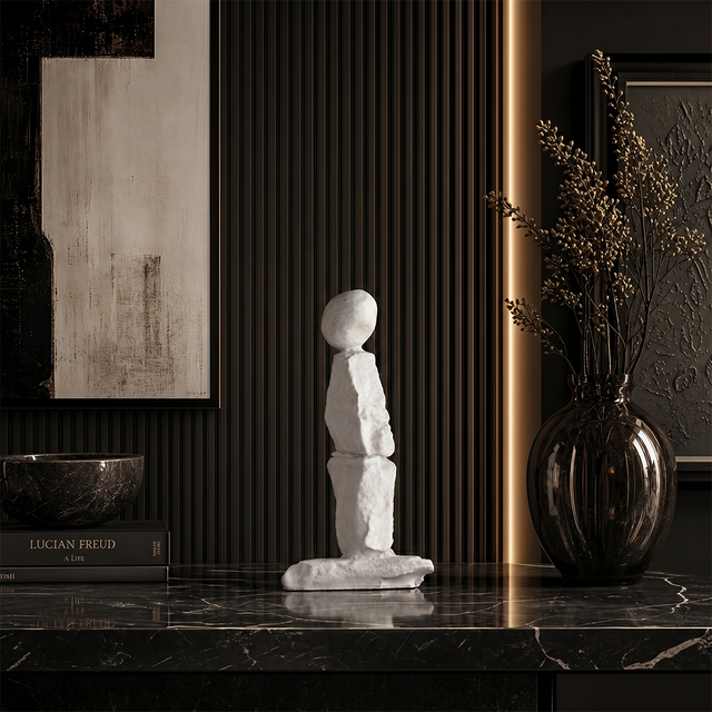 Minimalist human statue on black marble side table