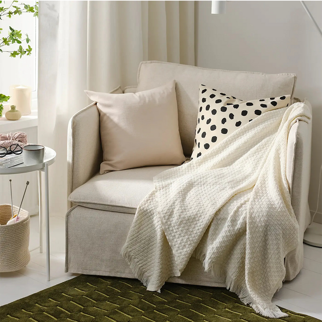 Off-white throw blanket on sofa