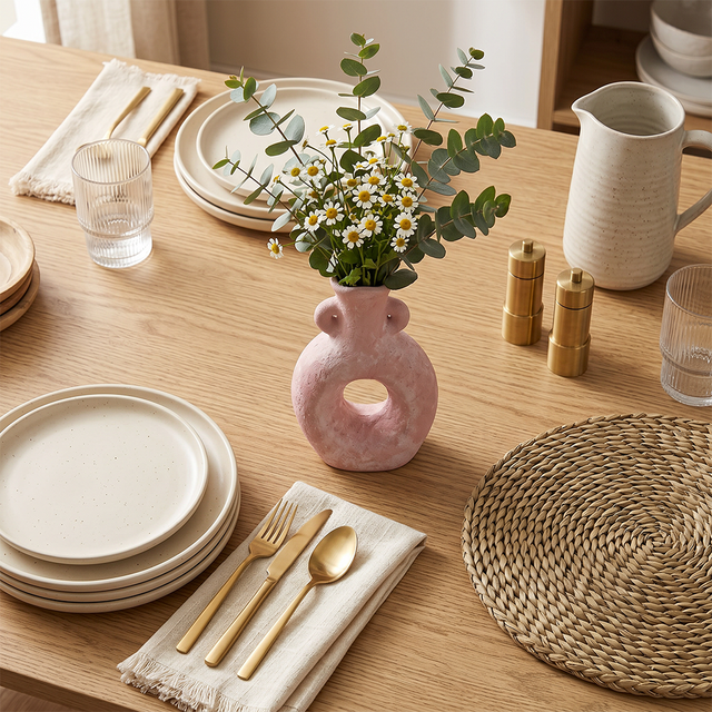 Pink ring vase on rustic dining table