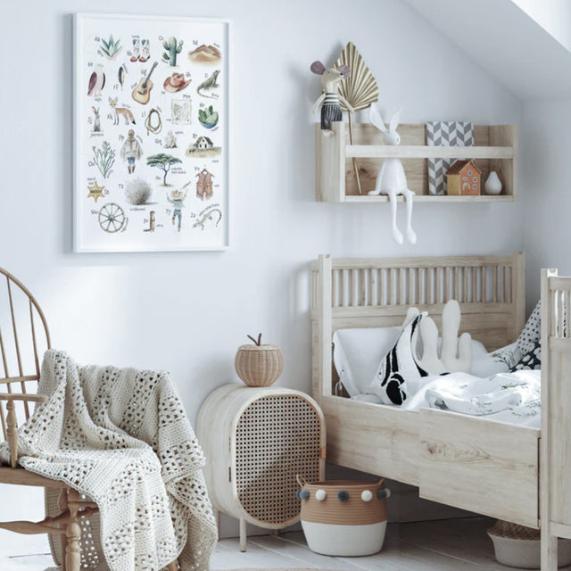 Scandinavian Rope Woven Toy Clothing Storage Basket with Pom Poms Beside the Bed