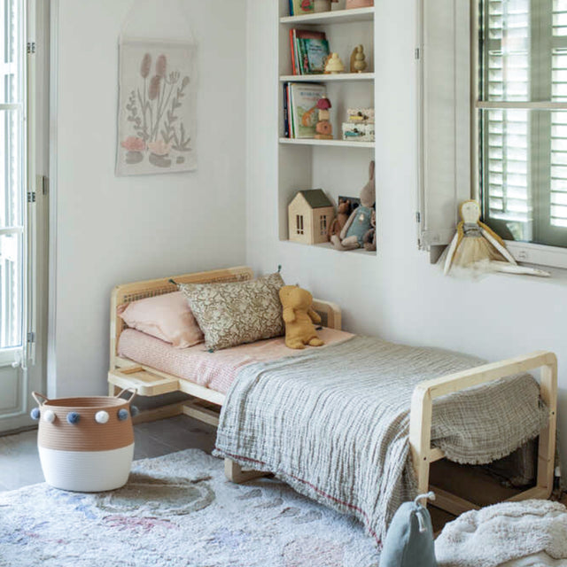 Scandinavian Rope Woven Toy Clothing Storage Basket with Pom Poms on the Floor