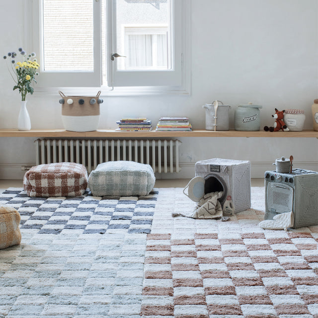 Scandinavian Rope Woven Toy Clothing Storage Basket with Pom Poms on the Table