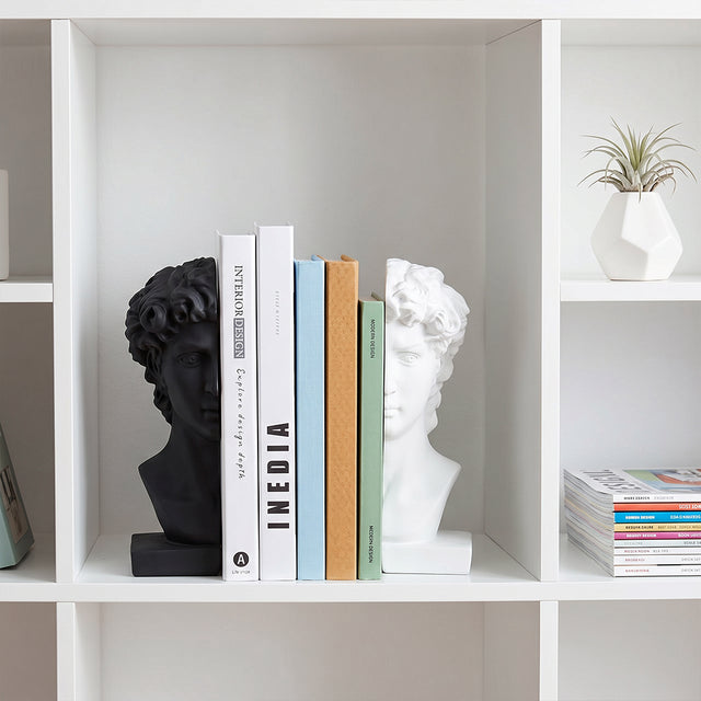 Sculpture bookends displayed in white cube shelf
