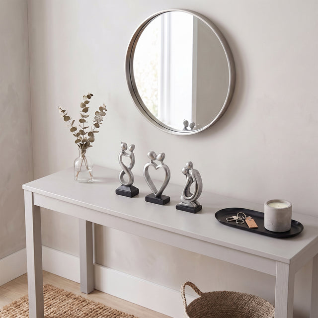 Silver Couple Sculptures On Console Table