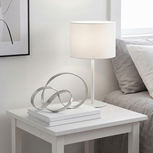 Silver intertwined rings on living room side table