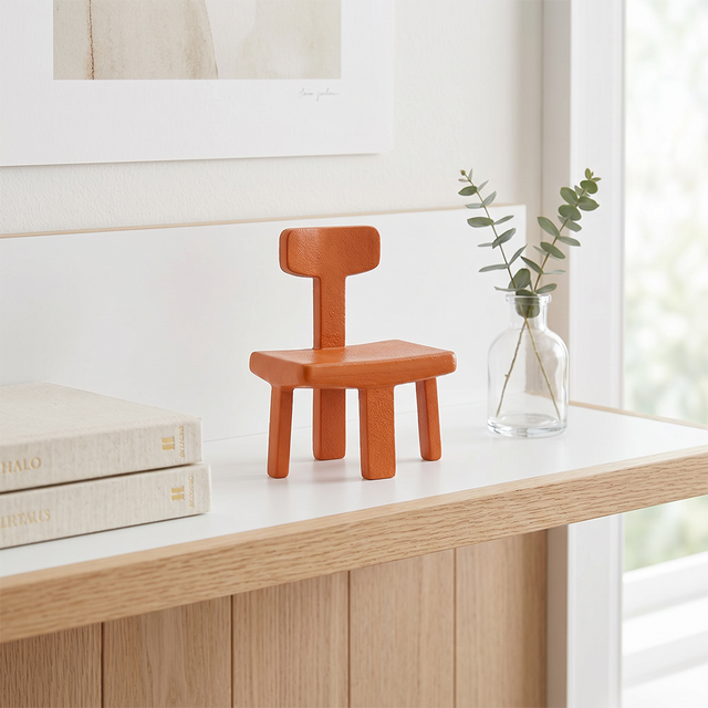 Small chair sculpture on light wood side console