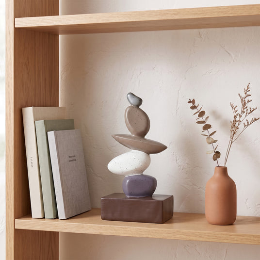 Stacked Stone Decor On Wooden Shelf