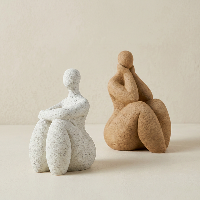 Two-minimalist-seated-human-sculptures
