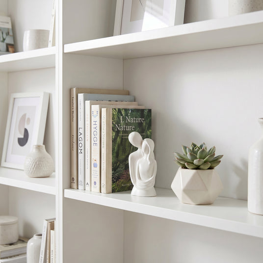 White Couple Sculpture On White Shelf