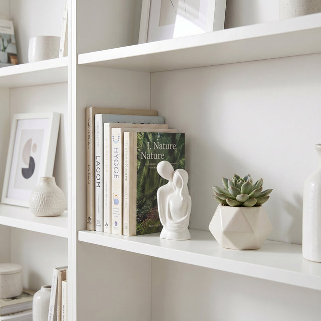 White Couple Sculpture On White Shelf