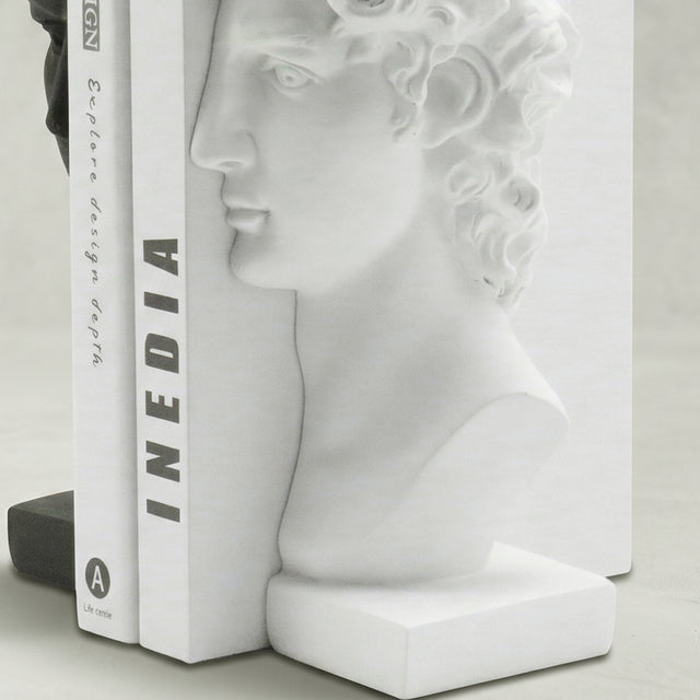 White sculpture bookend with standing books