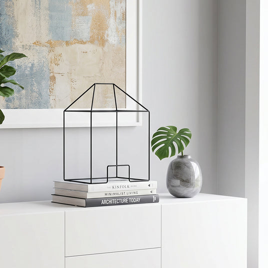 Wire house decor on white cabinet