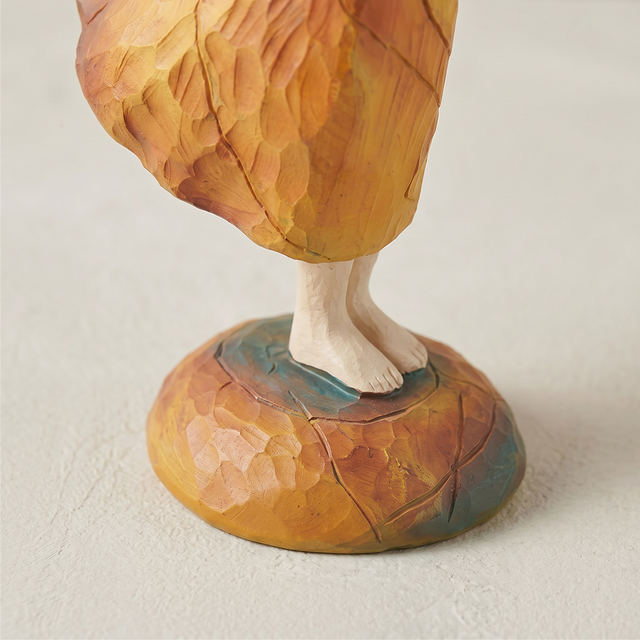 angel holding bird figurine feet base detail