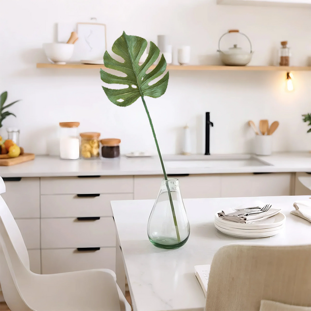 artificial monstera leaves on table