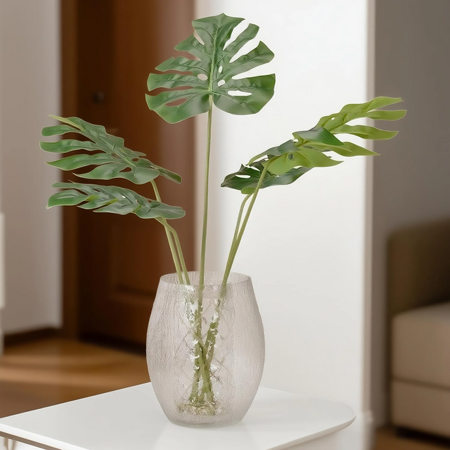 artificial monstera leaves on table