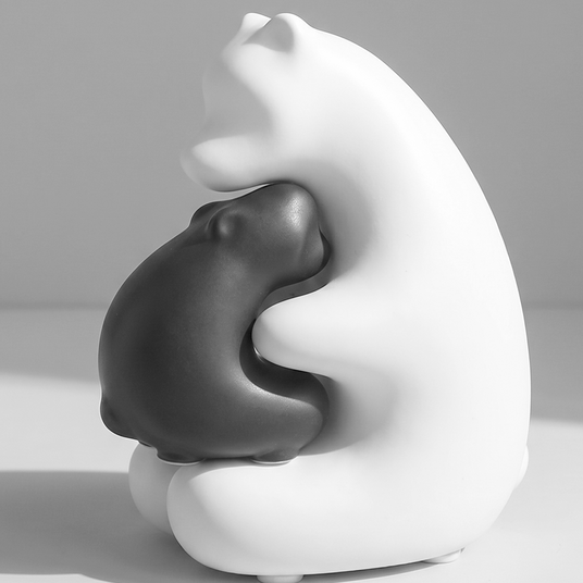 black and white hugging bears figurine side view