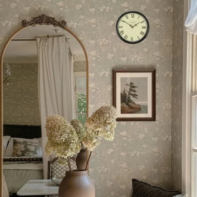 black wall clock hanging on the wall