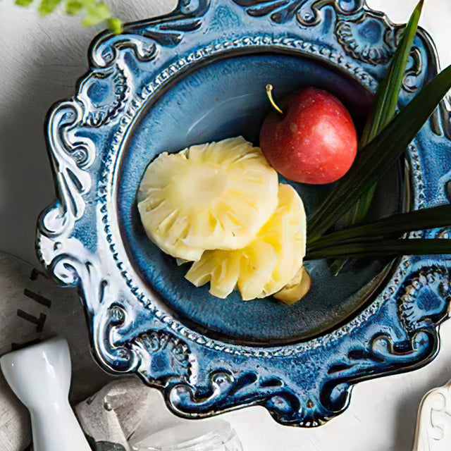 blue ceramic bowl holding fruits