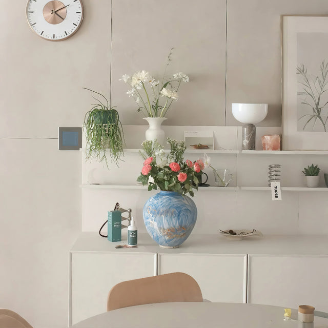 blue ceramic flower vase on the shelf