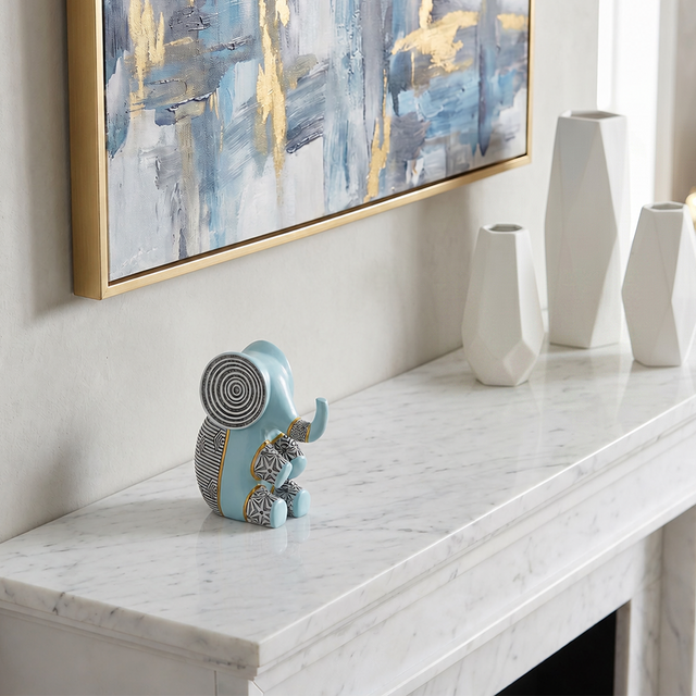 blue resin elephant on marble mantel