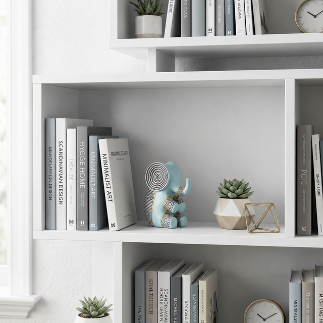 blue resin elephant on white bookshelf