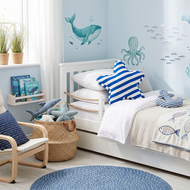 blue starfish pillow on nautical kids bed