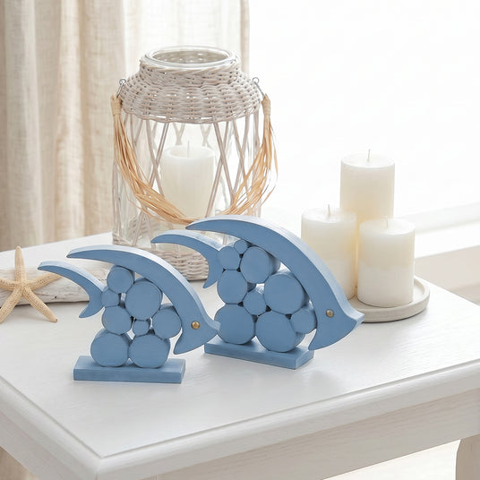 blue wooden dolphins on table with candles and lantern