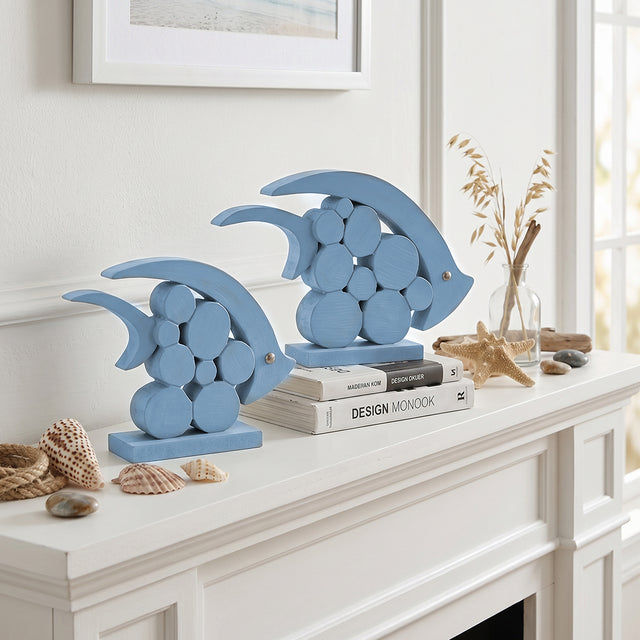 blue wooden dolphins on white mantel with seashells