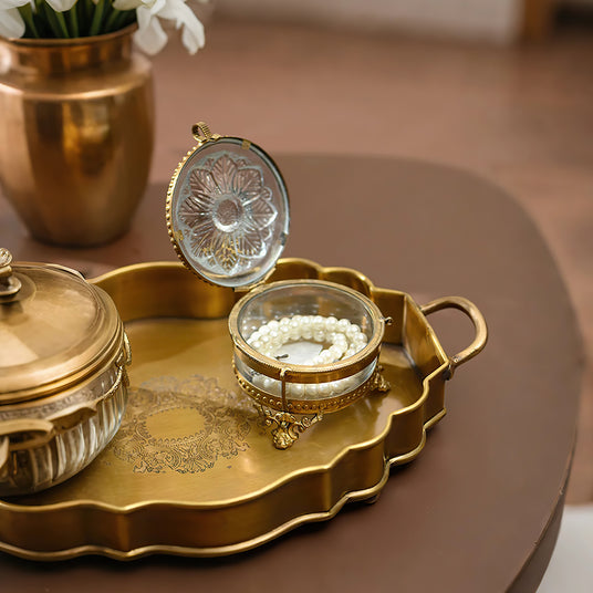 brass and glass carved decorative storage jar jewelry on the table