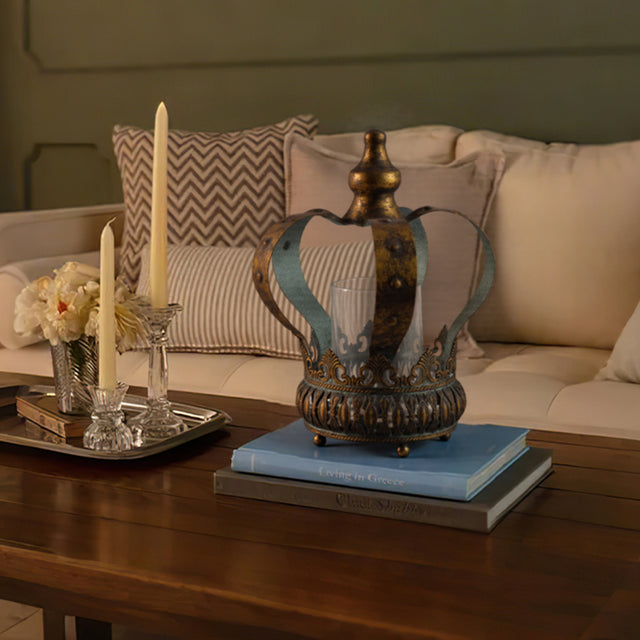 bronze metal crown hurricane candle holder on books