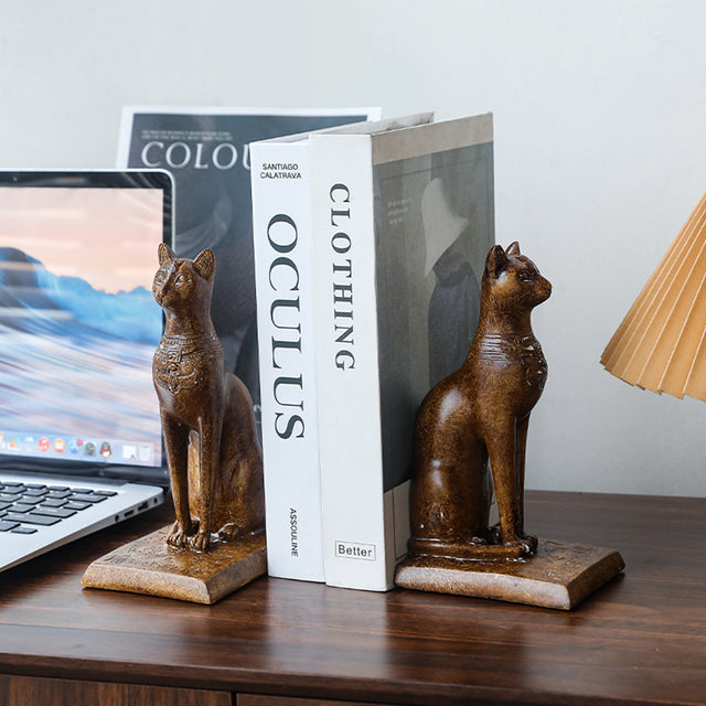 brown cat bookend beside the computer