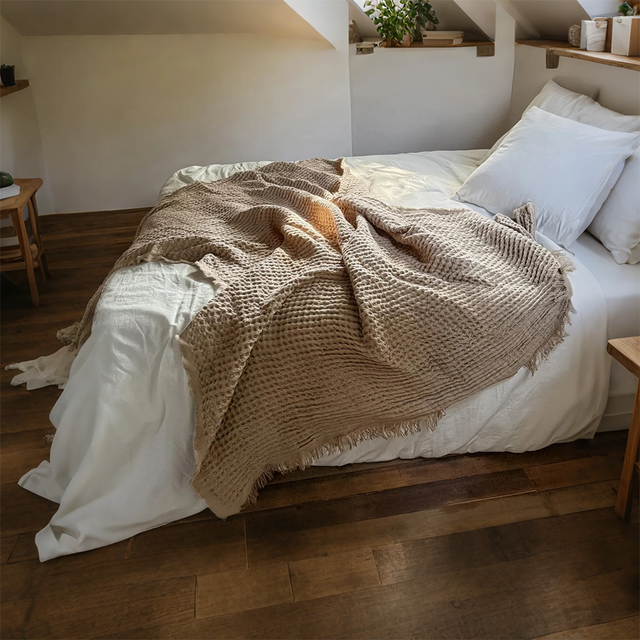 brown throw blanket on bed