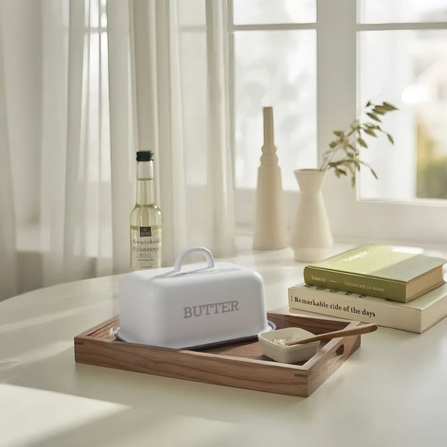 butter dish with lid on the wooden tray
